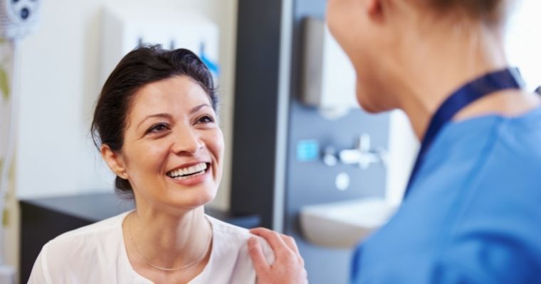 Woman smiling with sedation dentist.