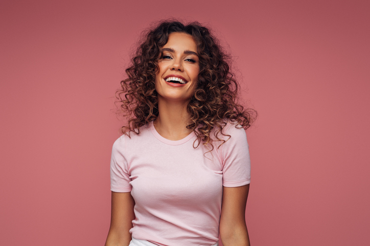 Young woman in pink shirt smiling