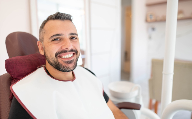 Happy man sitting in a dentist’s chair